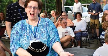 A woman holding a necklace to be auctioned
