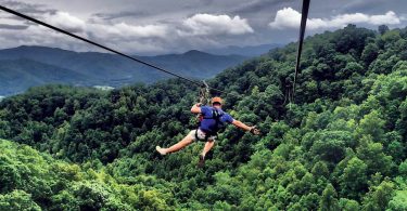 ziplining with mountains in the background