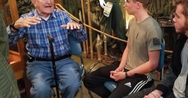 D-Day veteran George Sarros, age 94 tells campers Nathan Flake, Ethan Swords, and Jacob Flake about Normandy invasion. Photo by Janis Allen