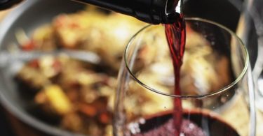a glass of wine being poured