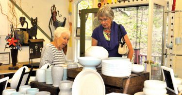 two women looking at pottery
