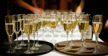 two trays of champagne glasses